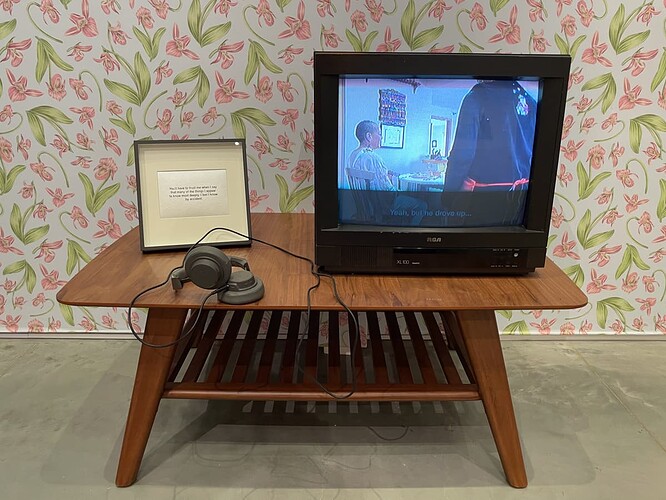 Chloë Bass: Cutting Room Floor #1 (Carroll Family), 2024, Digital video (color, sound); photographic stills on paper; text-based art on paper; installation elements (monitors, furniture, wallpaper).